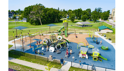Elevated view of children playing at a large outdoor playground.